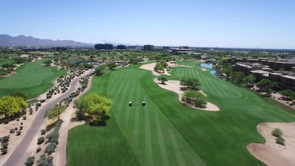 Aerial hight angle long distance tilt down on golfer and carts in the fairway, ​Scottsdale. ArizonaConcept: exercise, charity, Folds of Honor Arizona,