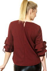 Woman wearing burgundy top