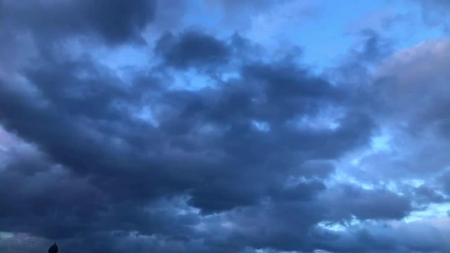 Dark clouds time lapse on a rainy day sunset.