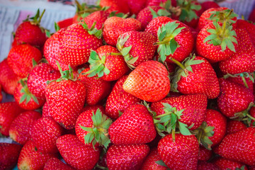Ripe strawberries pile at street market.