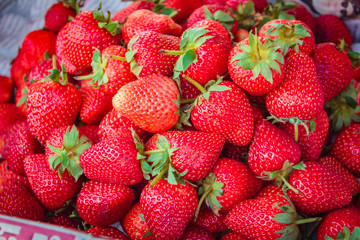 Ripe strawberries pile at street market.
