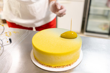 Modern european cake. Mousse dessert covered with yellow velour. Sweet dessert and tea party. French cuisine. Flowers theme. Copy space
