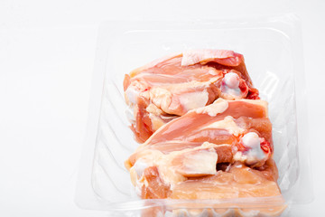 Chicken thighs in plastic pack from supermarket, ready to cook.