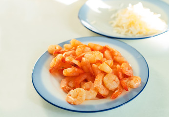 boiled shrimps lie in a plate on the table