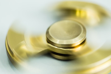 golden color metal spinner toy closeup detail view