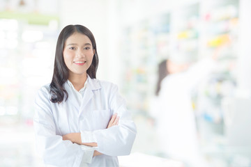 Beautiful asian female pharmacist smiling in drugstore