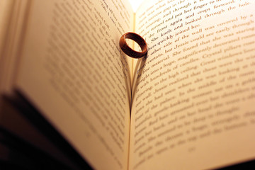 Fototapeta premium The ring in the book. Wooden ring. Abstract photo
