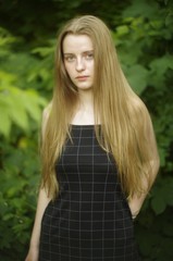 Naklejka premium beautiful young blonde with long flowing hair on a blurry background