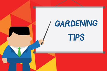 Conceptual hand writing showing Gardening Tips. Business photo text Proper Practices in growing crops Botanical Approach Businessman standing in front projector pointing project idea.