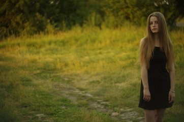 beautiful young blonde with long flowing hair on a blurry background
