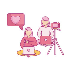 group of women seated using laptop computer with photographic camera