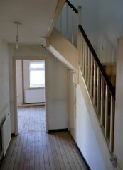 An Empty House Interior, Showing a Plain Wooden Staircase with Handrails and Spindles.