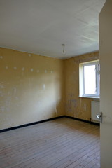 A Natural House Interior, Showing a Basic Empty Room with Stripped Walls and Floor boards in Need of Further Decoration. 