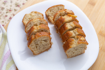 Sliced banana cake on white dish