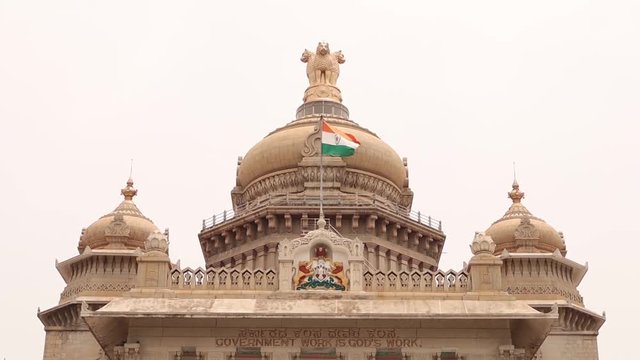 Waving Indian flag above the Vidhana Soudha or parliament or legislative assembly of Karnataka at Bangalore, India.