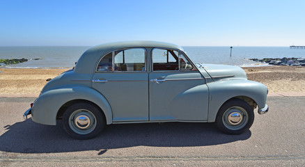 Fototapeta na wymiar Classic Grey Morris Oxford Motor Car Parked on Seafront Promenade.