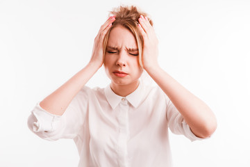 Frustrated girl suffering from head ache. Upset young woman with pain grimace holding head. Headache or loss concept