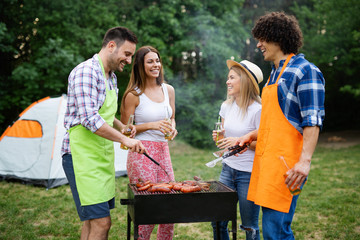 Happy friends enjoying barbecue and grill party outdoor