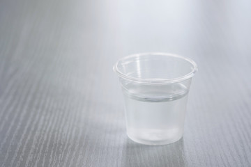 Drinking water in a clear glass on a white table