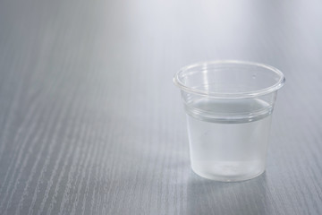 Drinking water in a clear glass on a white table