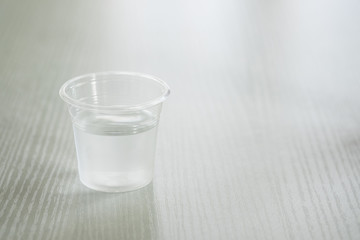 Drinking water in a clear glass on a white table