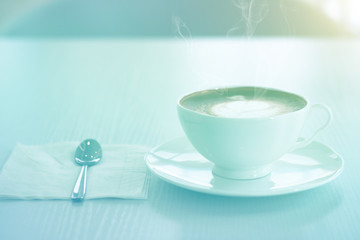 Cappuccino in a white cup on a white table