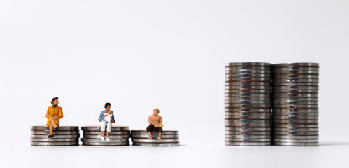 Divided coin piles and miniature people.