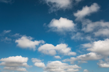 Naklejka na ściany i meble fluffy clouds on a sunny sky