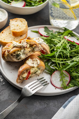 Roasted chicken breasts stuffed with mushrooms, green onion, pepper and garnished fresh salad and rocket salad.