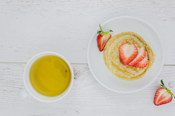 Breakfast with pancakes and strawberries
