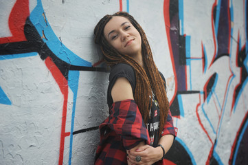 Smiling young woman with dreadlocks
