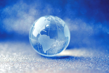 Fototapeta na wymiar Close up of glass globe in beautiful bokeh background - United States and Canada
