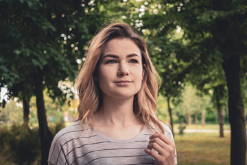 Thoughtful young woman outdoors in a park