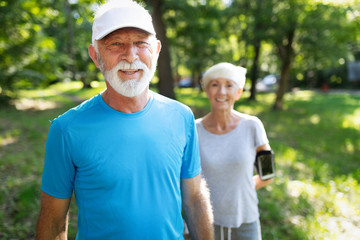 Mature couple jogging and running outdoors in city