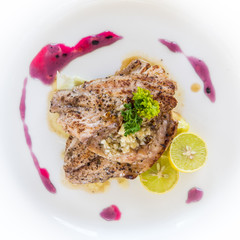 Grilled chicken with a decorated plate