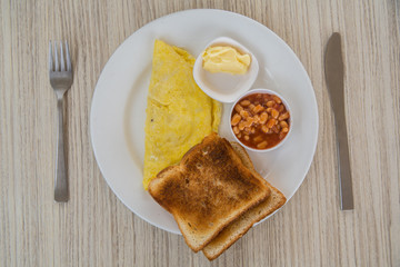 Omelette, toast and beans on a plate