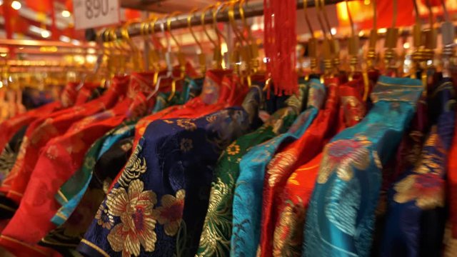 4K Traditional Chinese dress hanging on rack in shopping mall