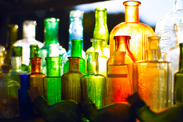 Colored glass bottles under light