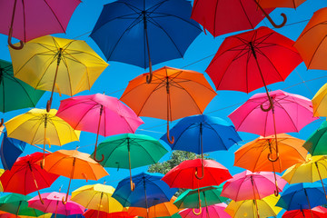 Colorful umbrellas in the sky as background. Street decoration.