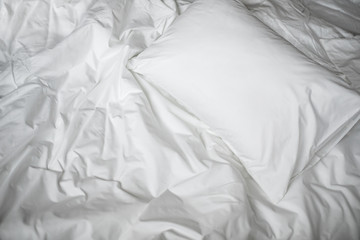 White messy bed top view