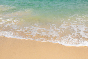 Close up of soft wave of ocean on the sand, background.