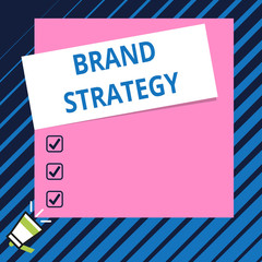 Conceptual hand writing showing Brand Strategy. Concept meaning Long term marketing support for a product Marketing Speaking trumpet on bottom and paper on rectangle background