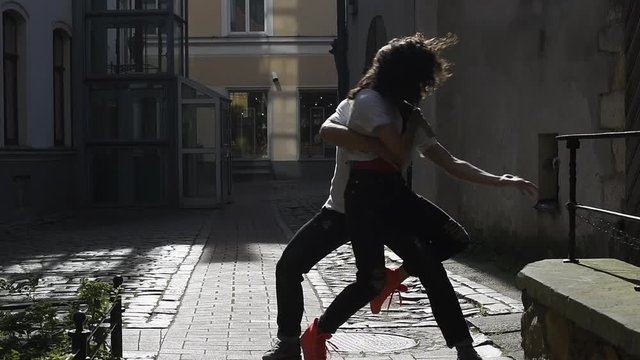 Couple dancing outdoor in town