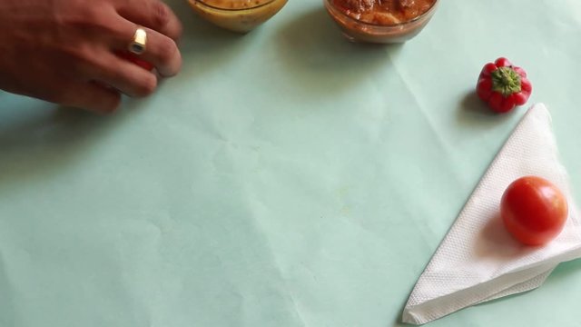 rotation Chole Bhature or Chick pea curry and Fried Puri served in terracotta crockery over green background.