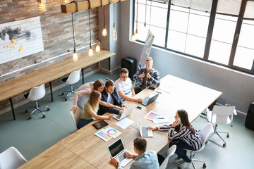 Young people having business meeting in modern office