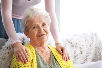 Caregiver with senior woman in nursing home