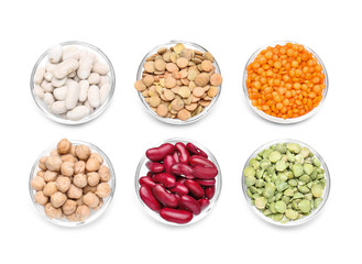 Bowls with different legumes on white background