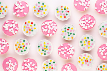 Colorful cupcakes on a white background.