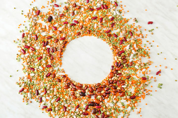 Frame made of different legumes on light background