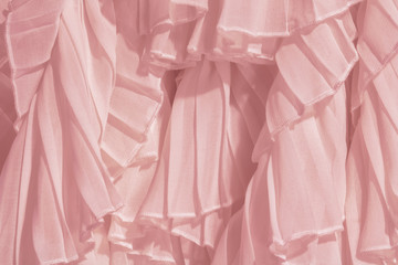 Amaranth pink color chiffon fabric folds. Rose dress with ruffles and frills. 